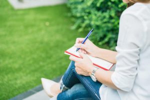 Student Writing At Park, Working Outdoor Women Work Business Job - Susi Lodola Counselling